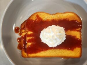 Brioche toast with spicy sauce and whipped cream